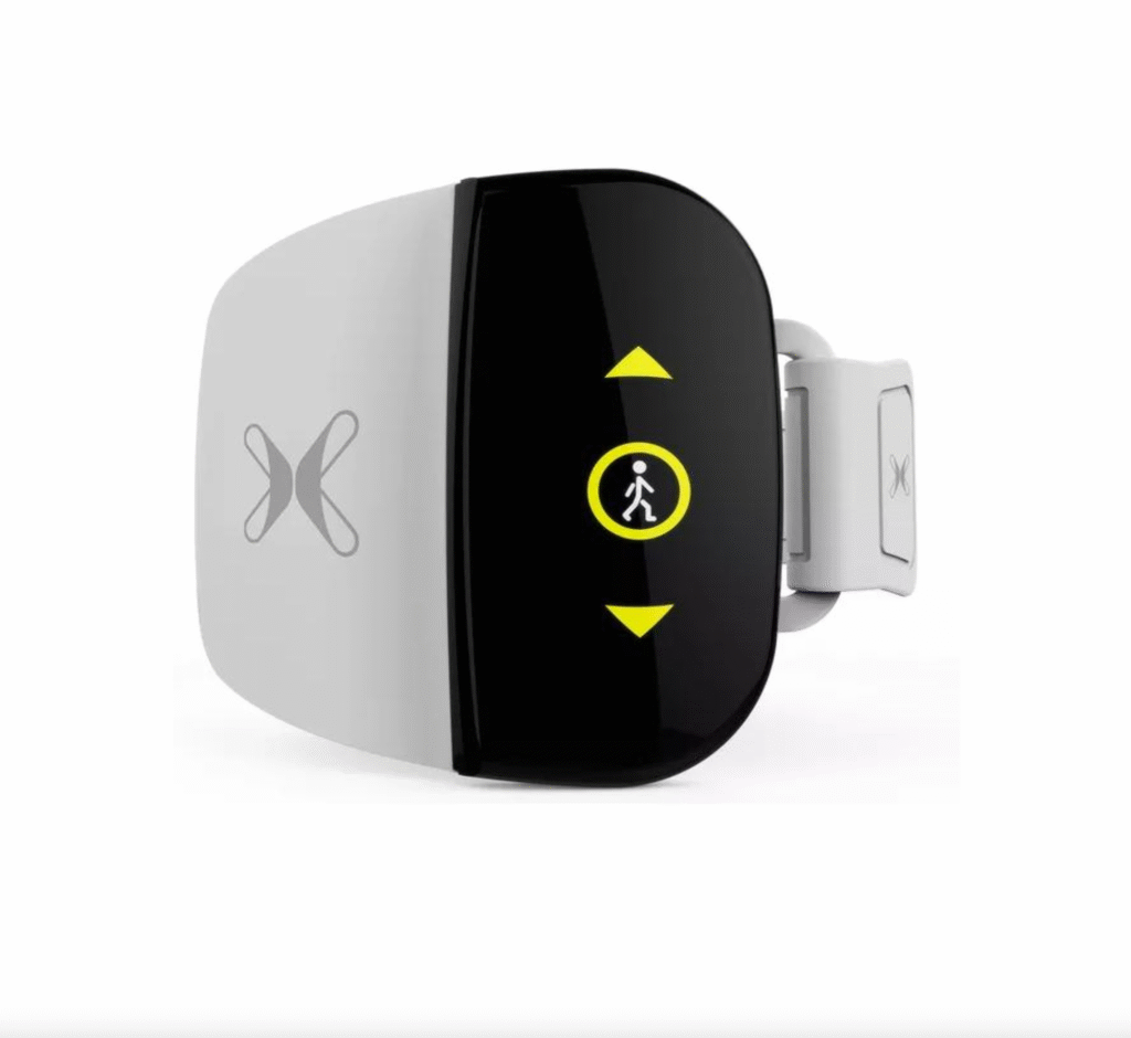 Picture of a grey and black XFT G4 leg stimulator. Front-on view with yellow control buttons